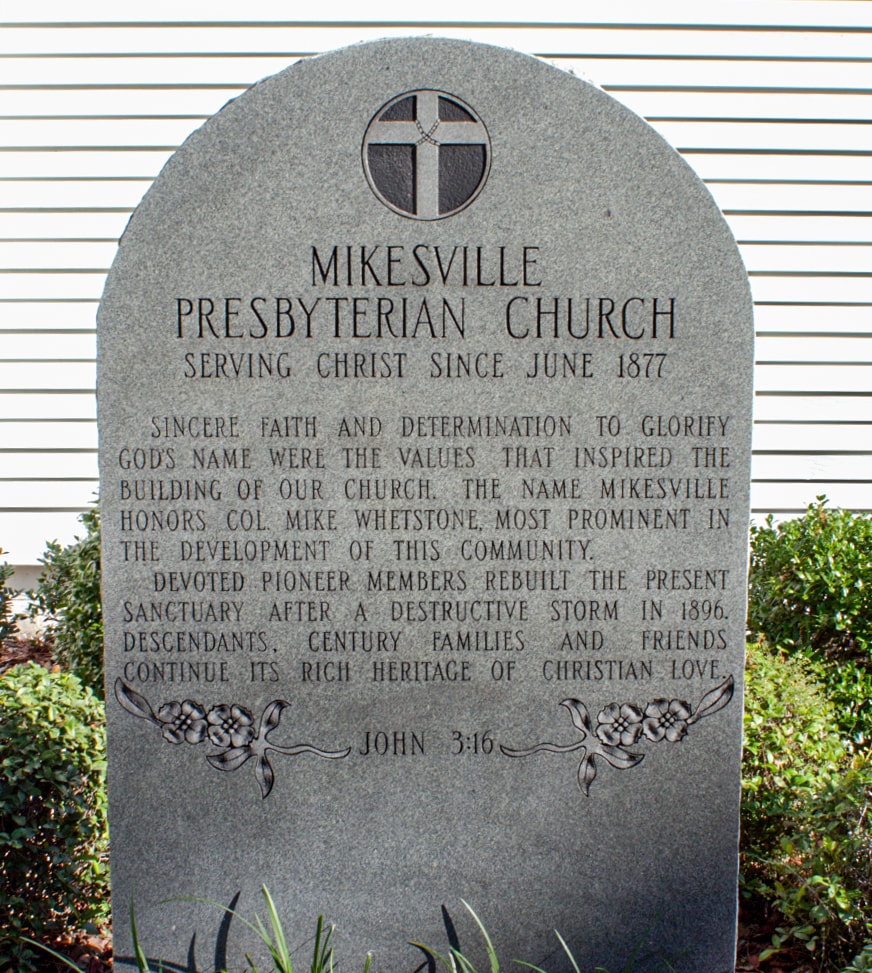 Stone monument at Mikesville Presbyterian Church reading Serving Christ Since June 1877